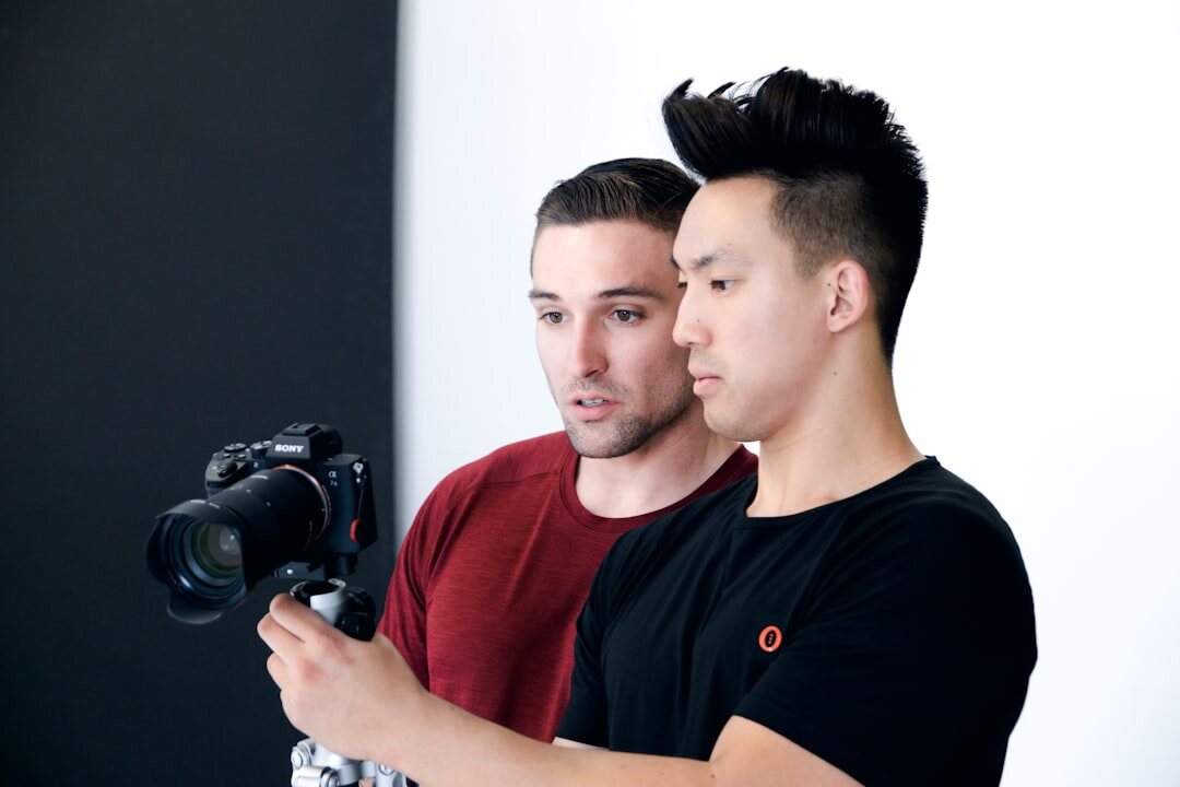 Studio portrait of a young male camera and switching instructor